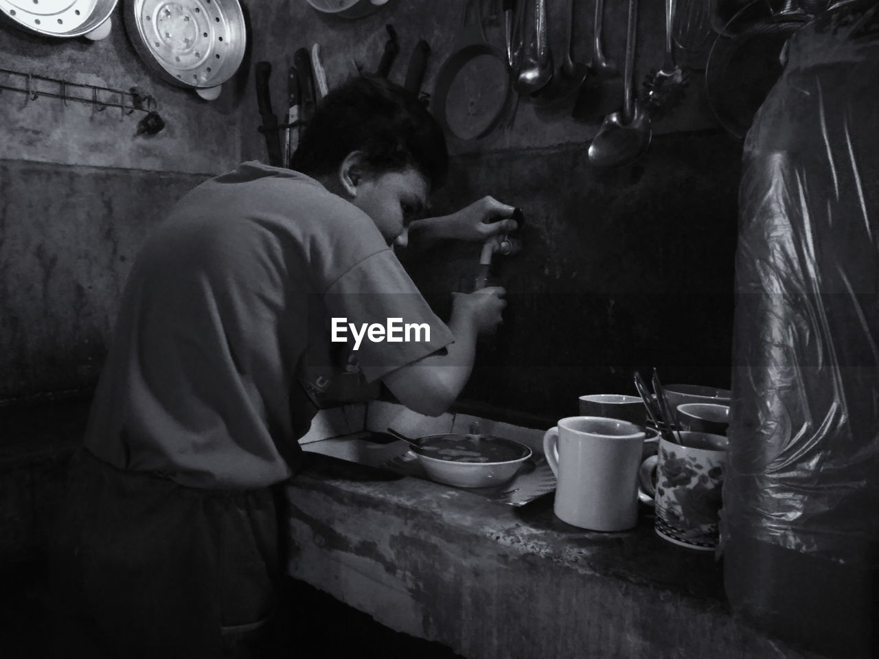 SIDE VIEW OF A YOUNG MAN HAVING FOOD