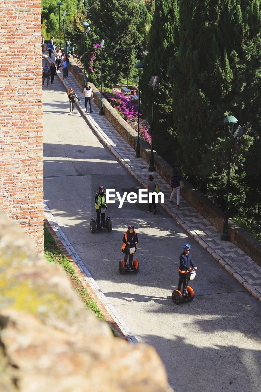 PEOPLE WALKING ON ROAD IN CITY