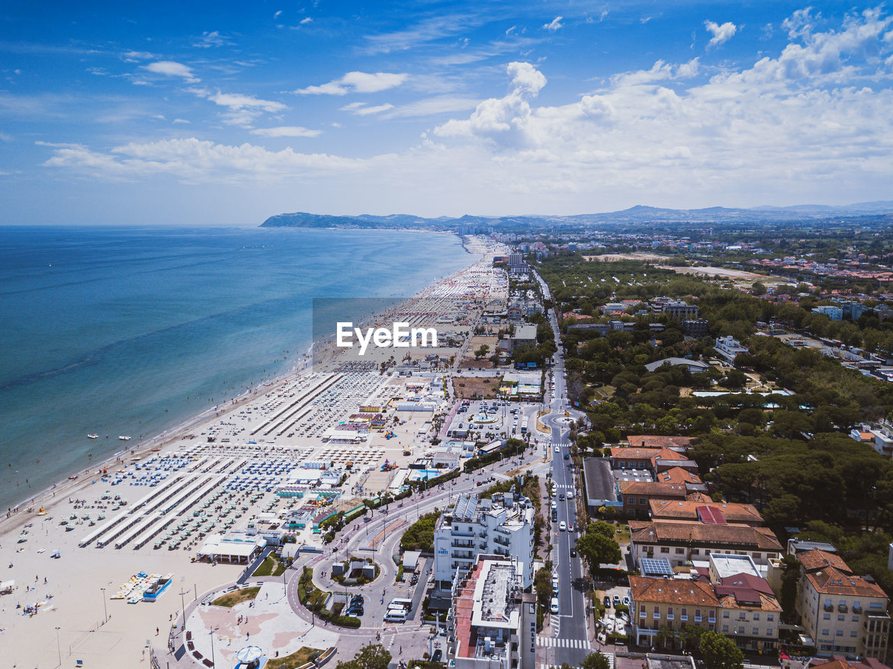 High angle view of buildings by sea against sky