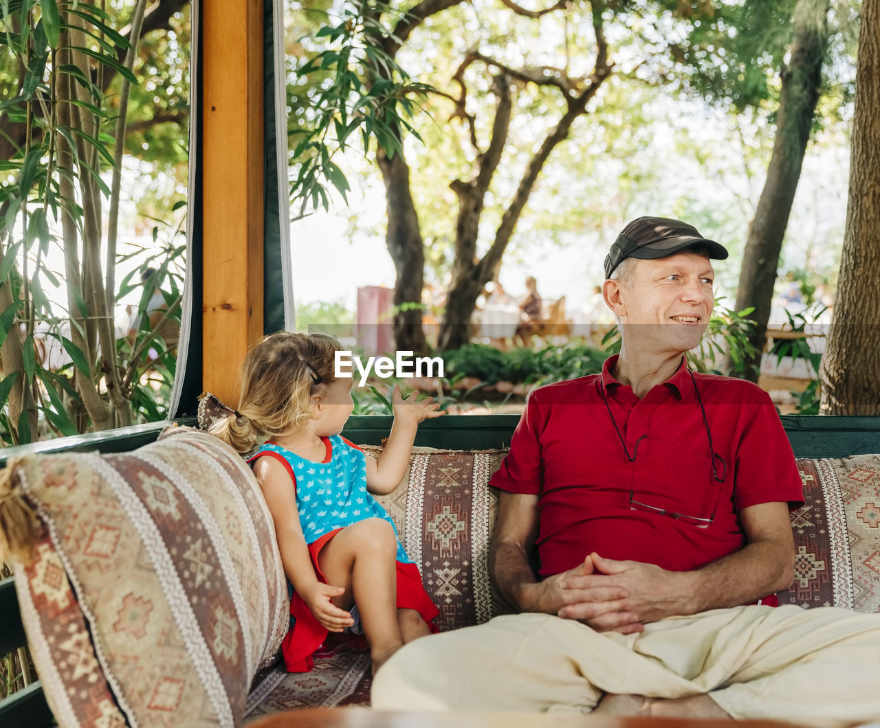 Grandfather and granddaughter relaxing on seat