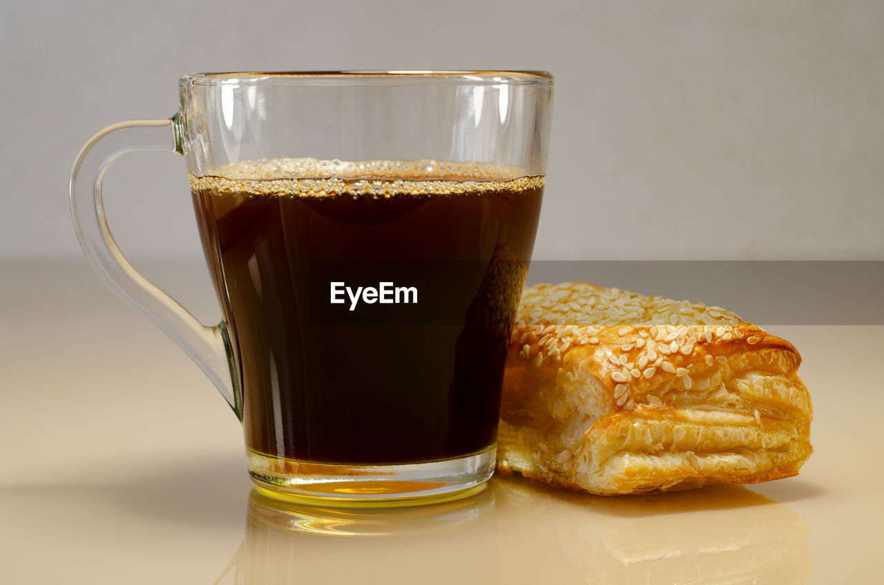 CLOSE-UP OF COFFEE AND GLASS OF JUICE