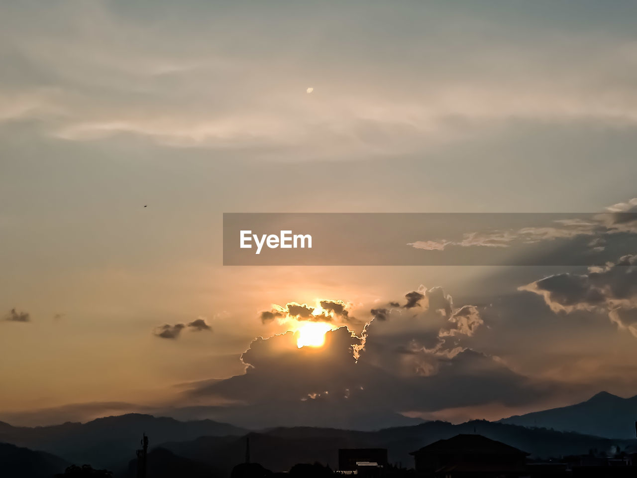 SCENIC VIEW OF SILHOUETTE MOUNTAINS AGAINST ORANGE SKY