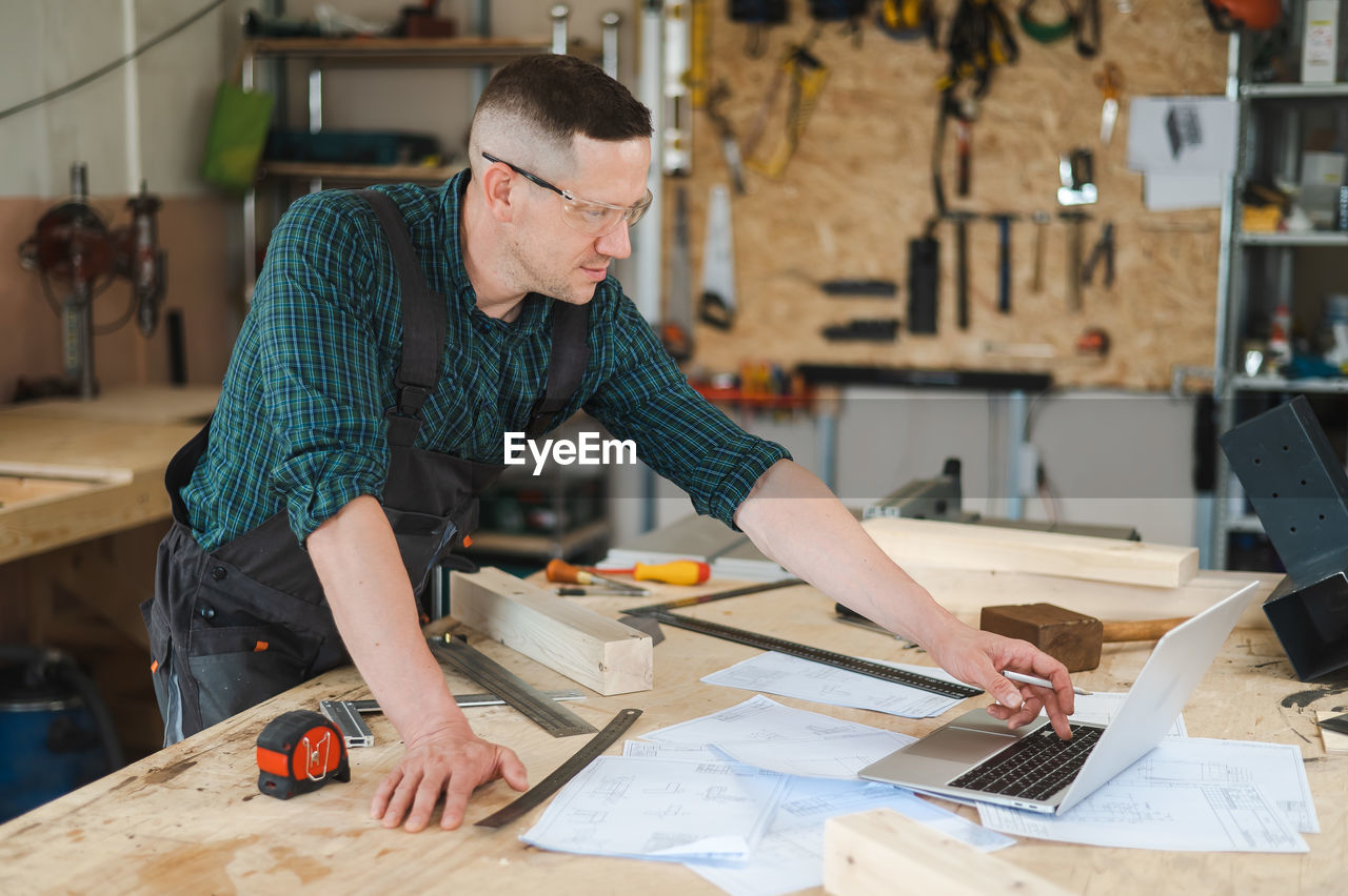 man working on blueprint