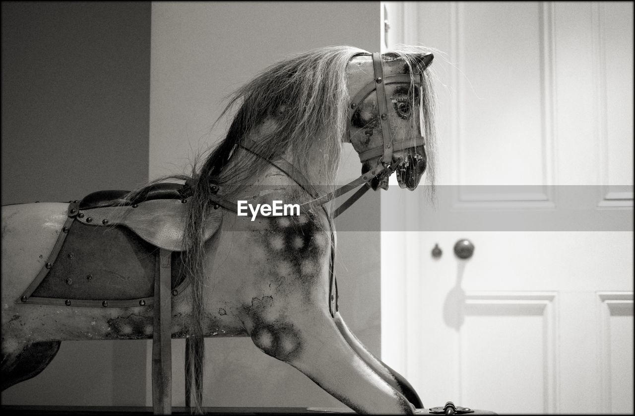 Close-up of rocking horse in house