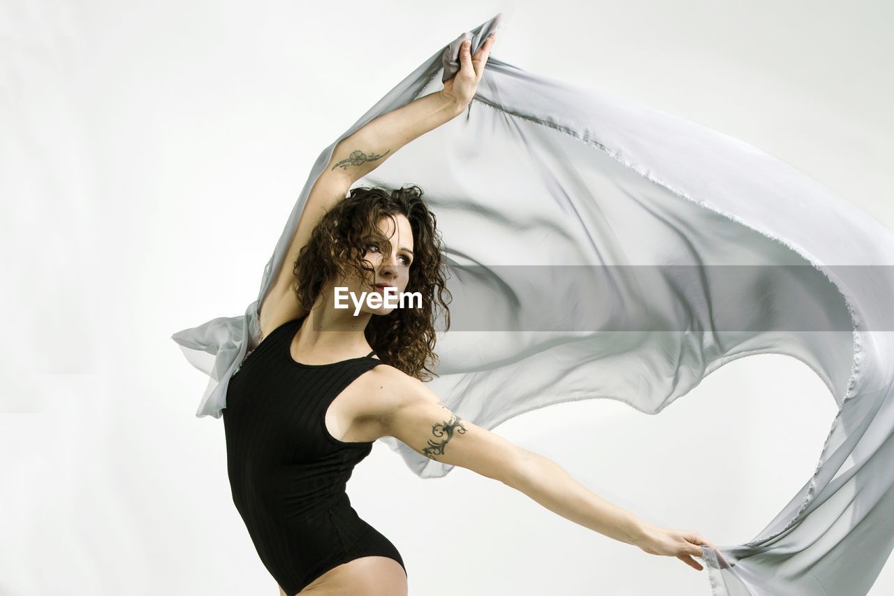 Woman dancing against white background