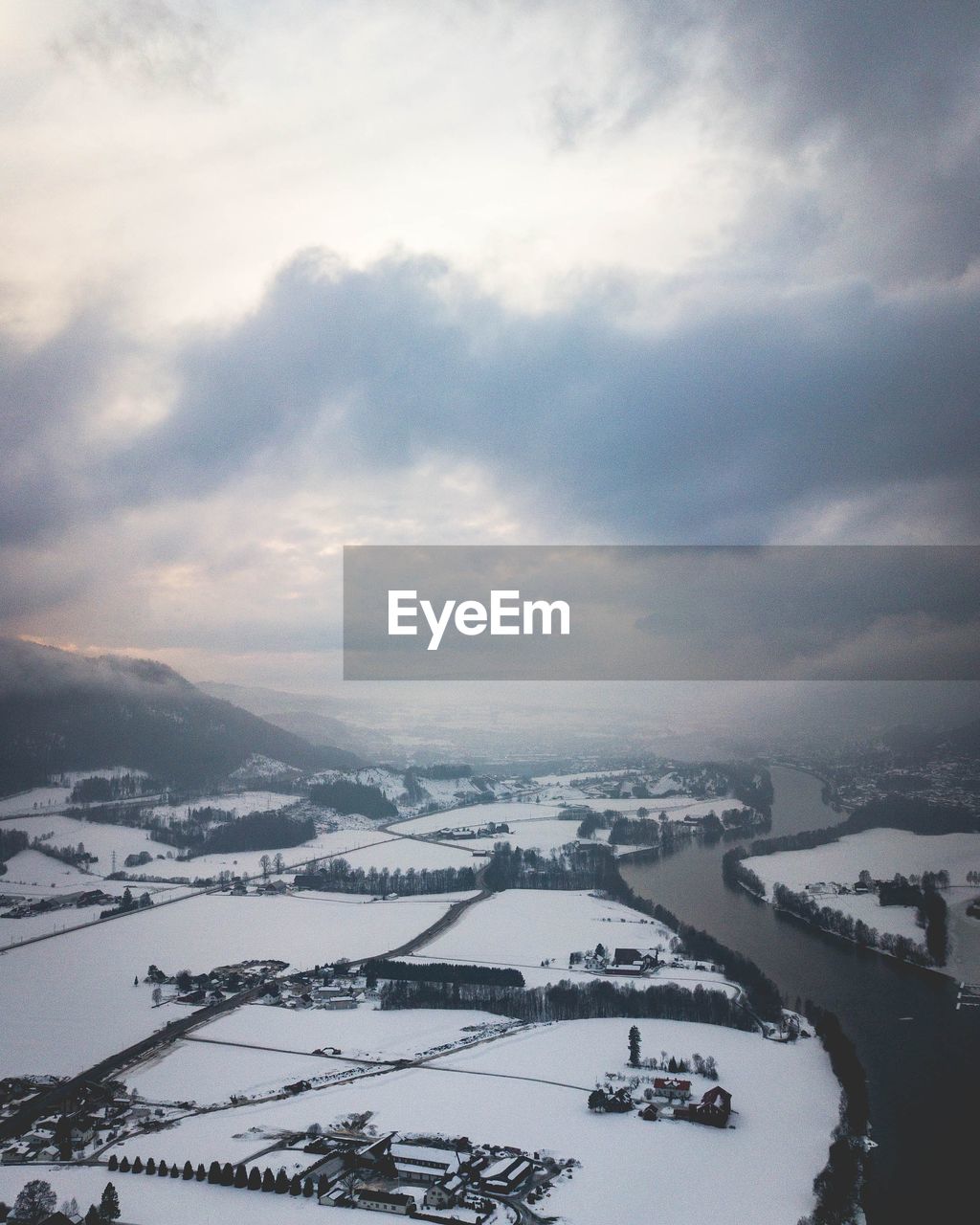 HIGH ANGLE VIEW OF SNOWCAPPED MOUNTAINS AGAINST SKY DURING WINTER