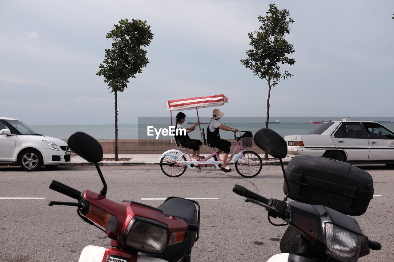 BICYCLES ON ROAD AGAINST SKY