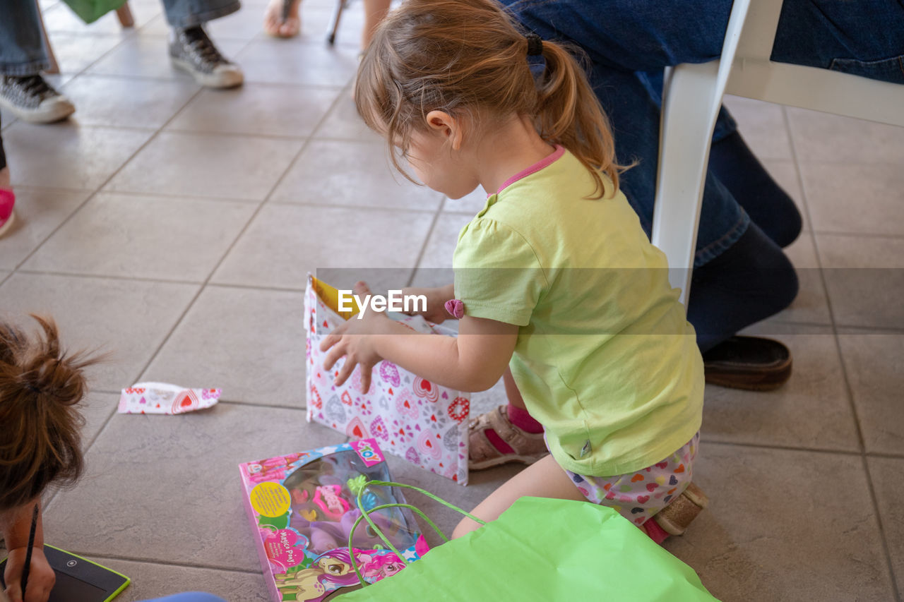 High angle view of women sitting on tiled floor