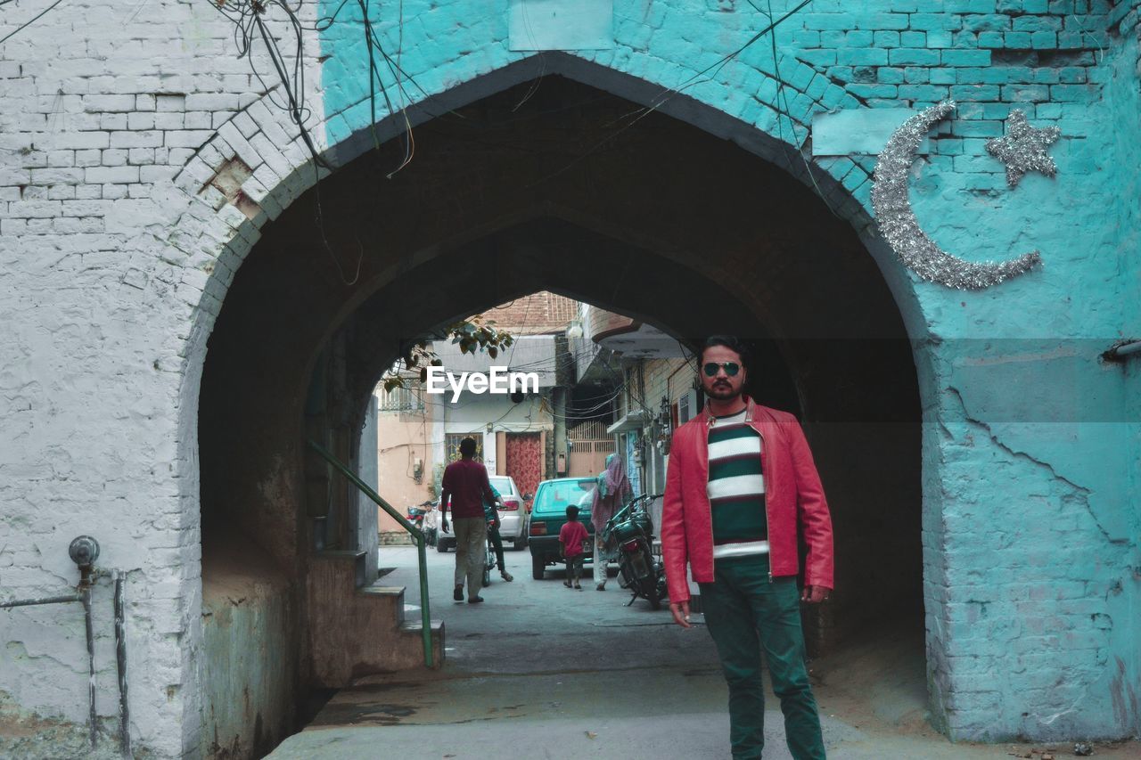 Portrait of man standing at historic building