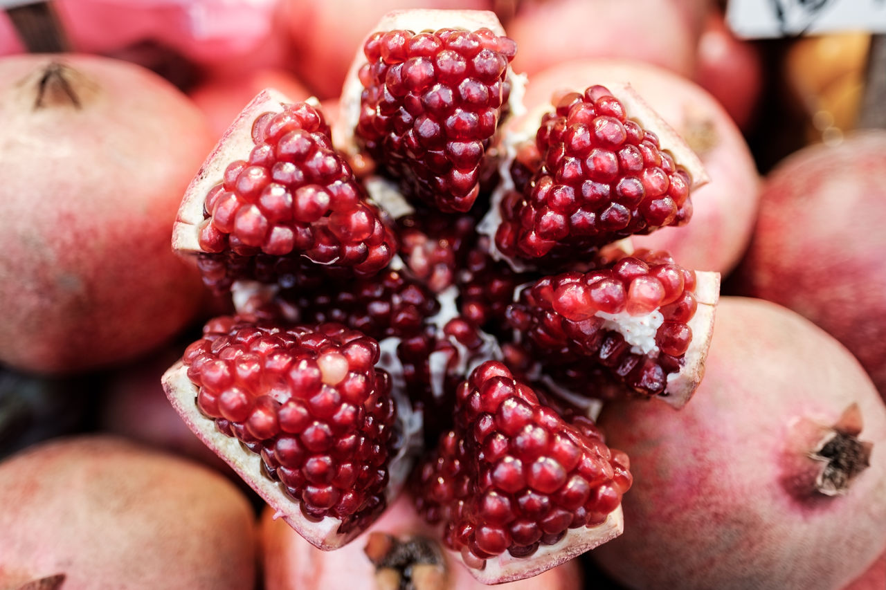 Fresh juicy, ripe pomegranate beautifully served at a local market, jerusalem, israel.