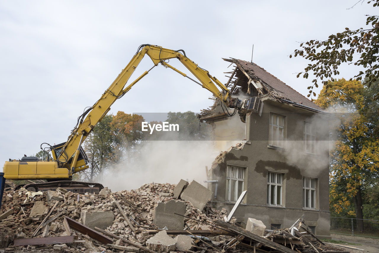 Machinery demolishing building