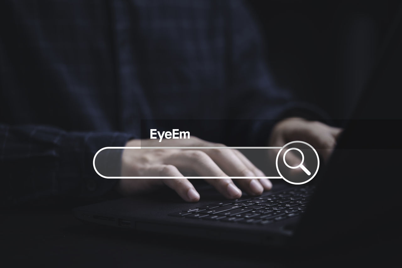wireless technology, technology, communication, computer, internet, computer network, hand, one person, adult, finger, laptop, computer equipment, indoors, using computer, black, close-up, studio shot, business, portability, using laptop, men, screenshot, portable information device, copy space, holding, black background, e-mail, smartphone, midsection, typing, computer keyboard, darkness