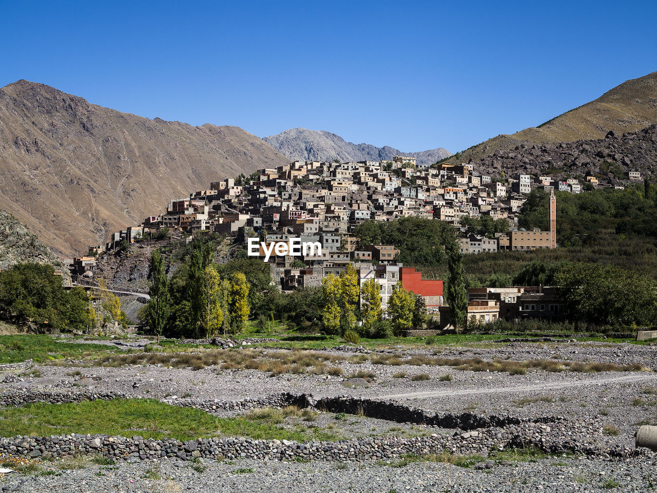 Houses and buildings against clear sky