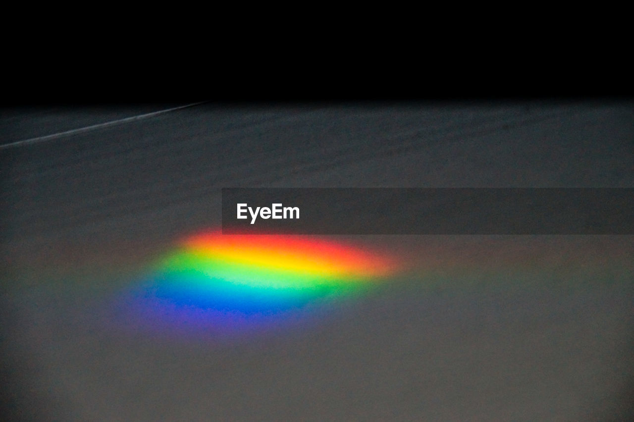 Close-up of multi colored light on black textile