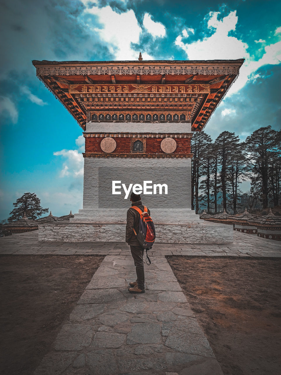 REAR VIEW OF WOMAN WALKING IN TEMPLE