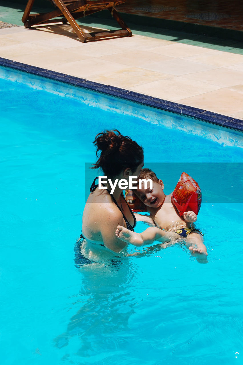 Mother with son in the swimming pool