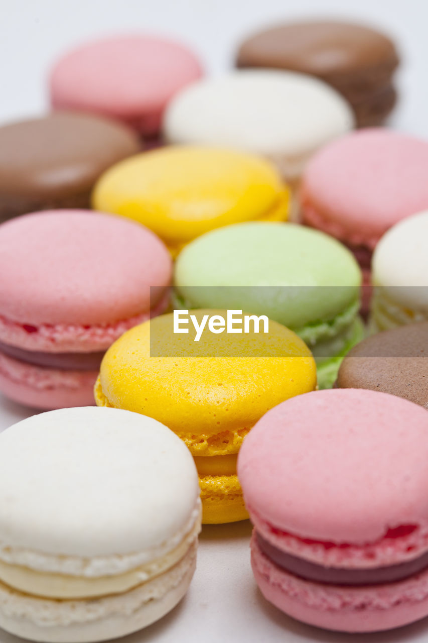 Close up of colourful macaroons on white background