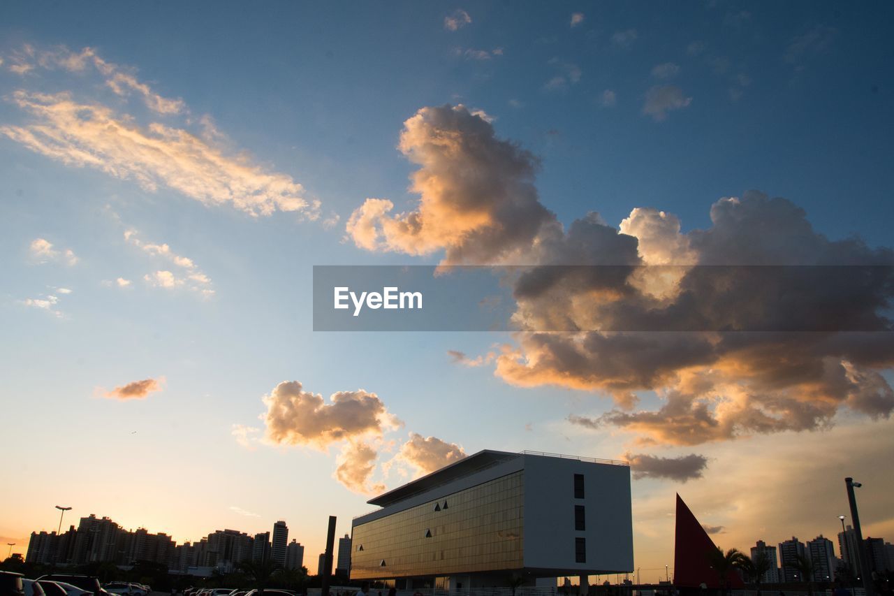 LOW ANGLE VIEW OF SILHOUETTE BUILDINGS AGAINST SKY DURING SUNSET