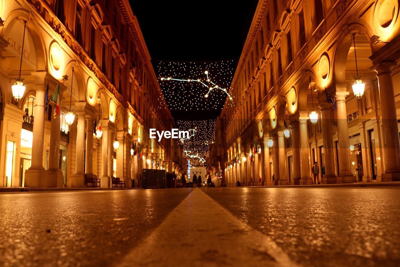 Street amidst historic buildings at night