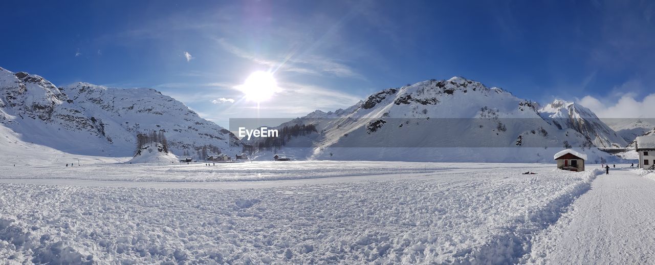 Scenic view of snow covered mountains against sky