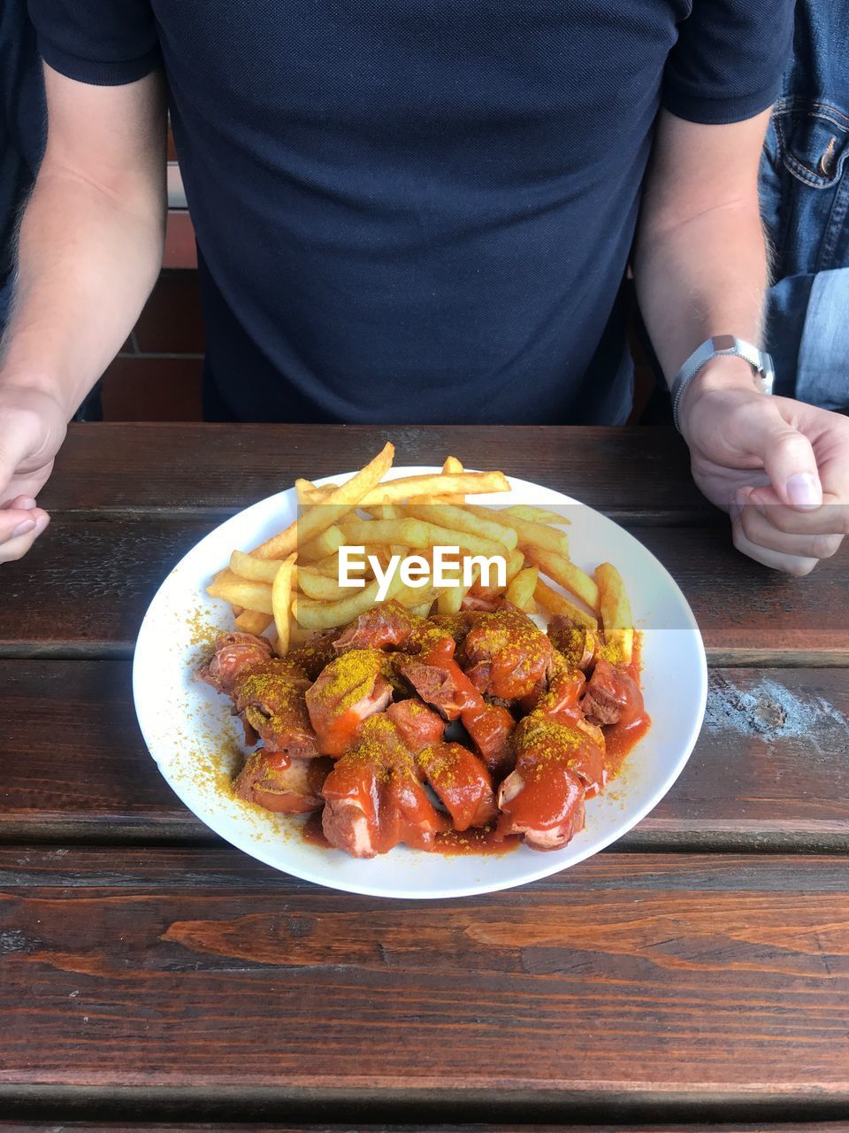 Midsection of man having food at table