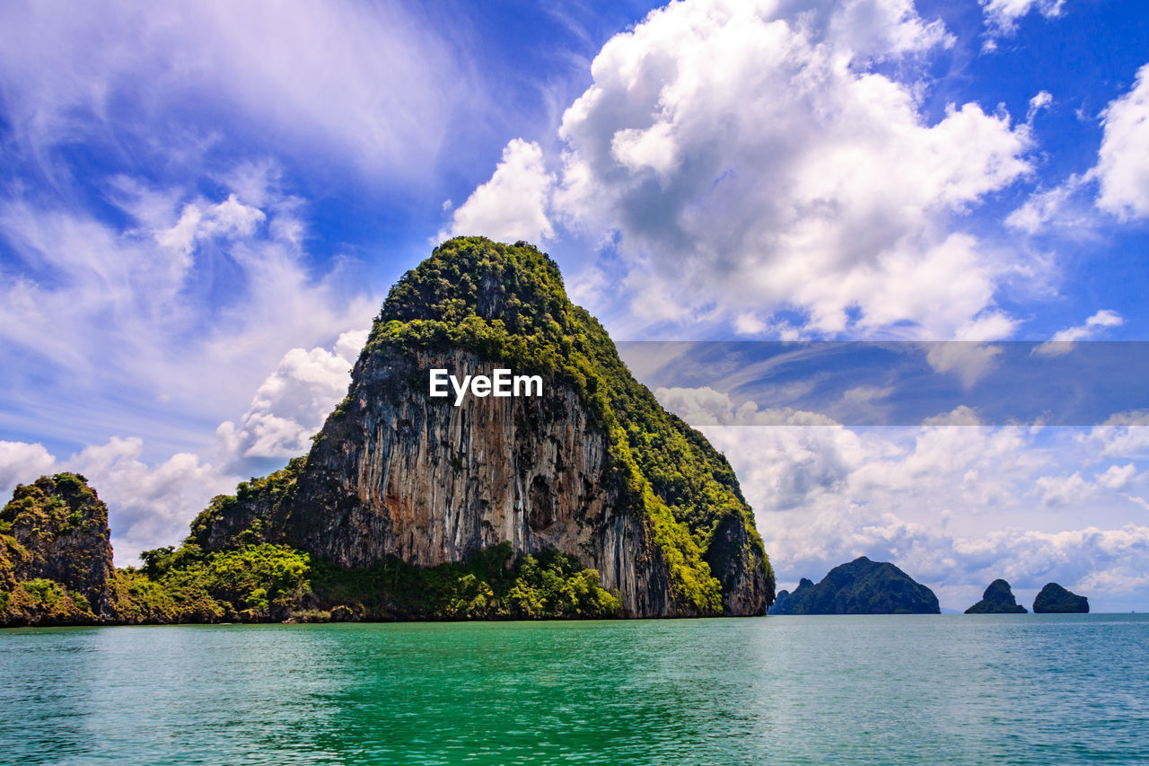 Scenic view of rock formation in sea against sky