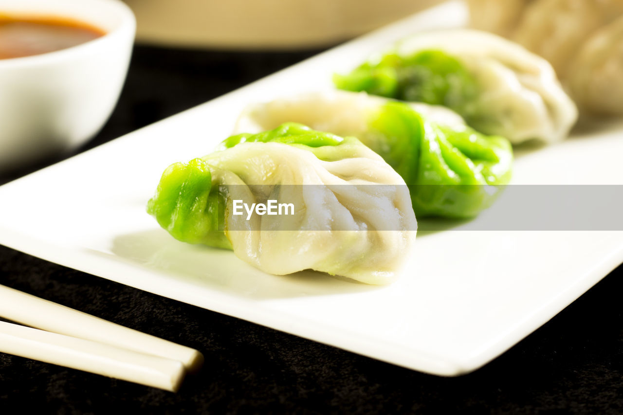 Close-up of chinese dumplings served in plate on table