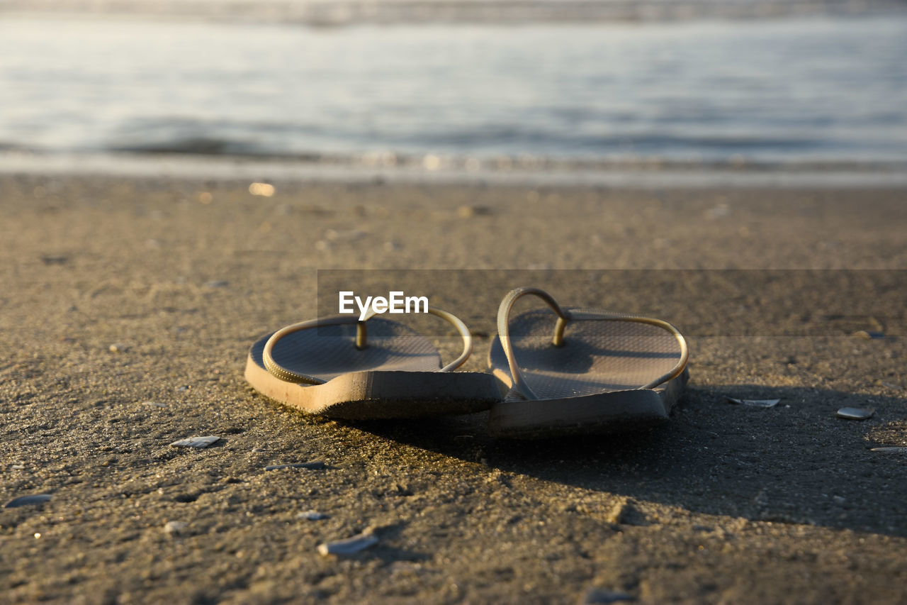 Pair of slippers on sand