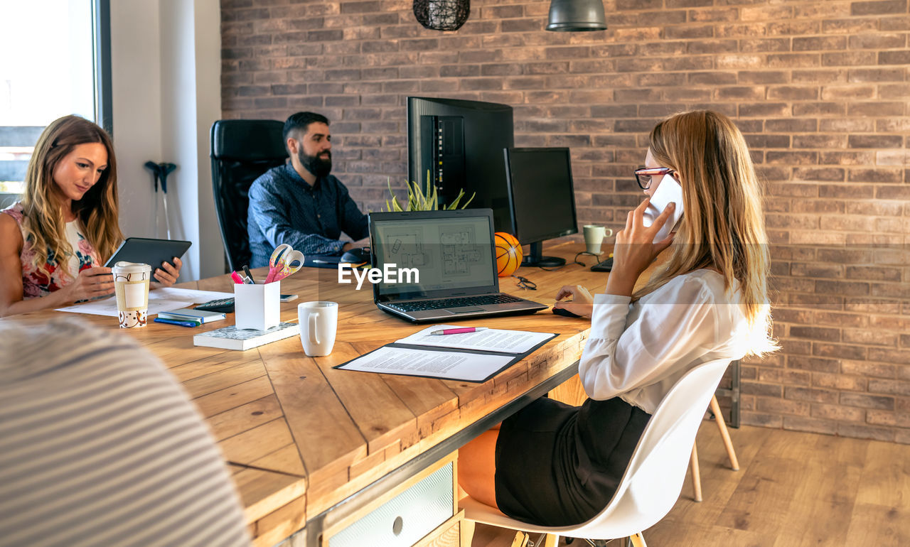 People working on table at office