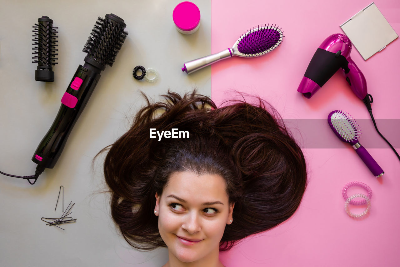 Woman with brown hair by personal accessories on table