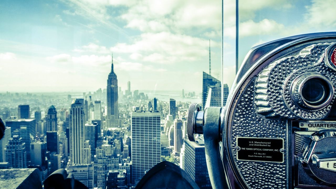 VIEW OF CITYSCAPE AGAINST CLOUDY SKY