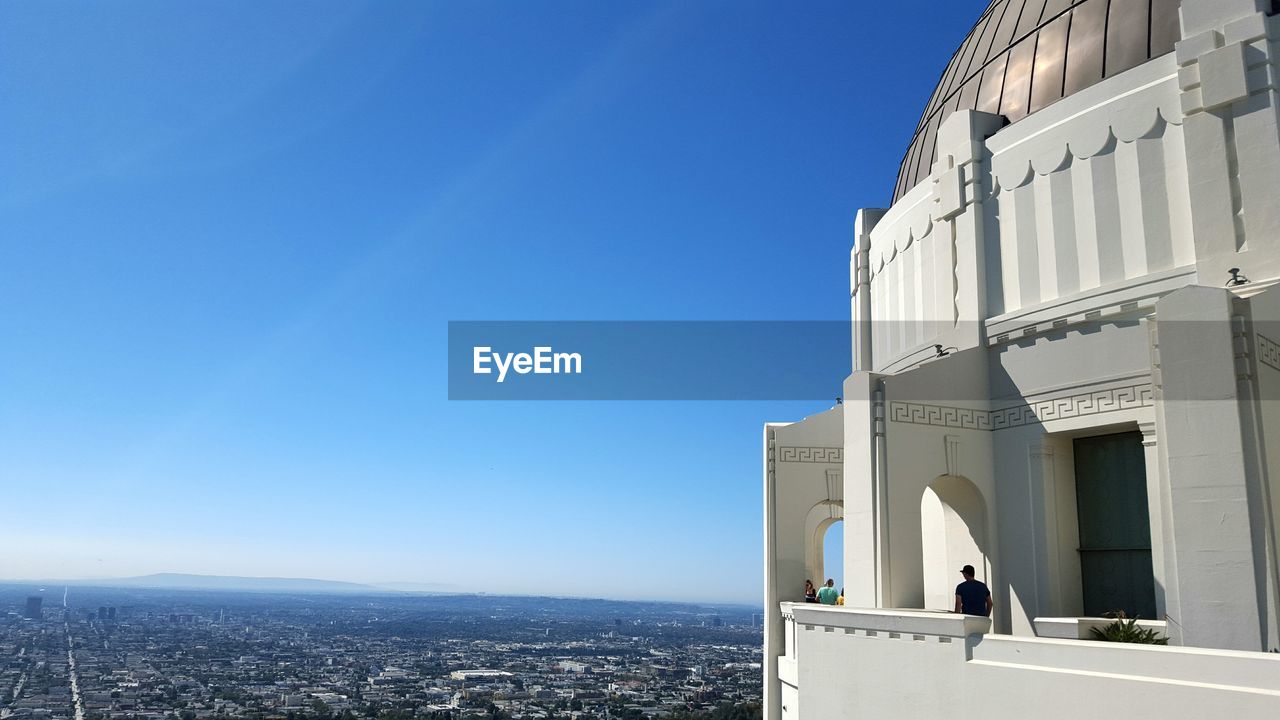 Griffith park observatory against clear blue sky on sunny day