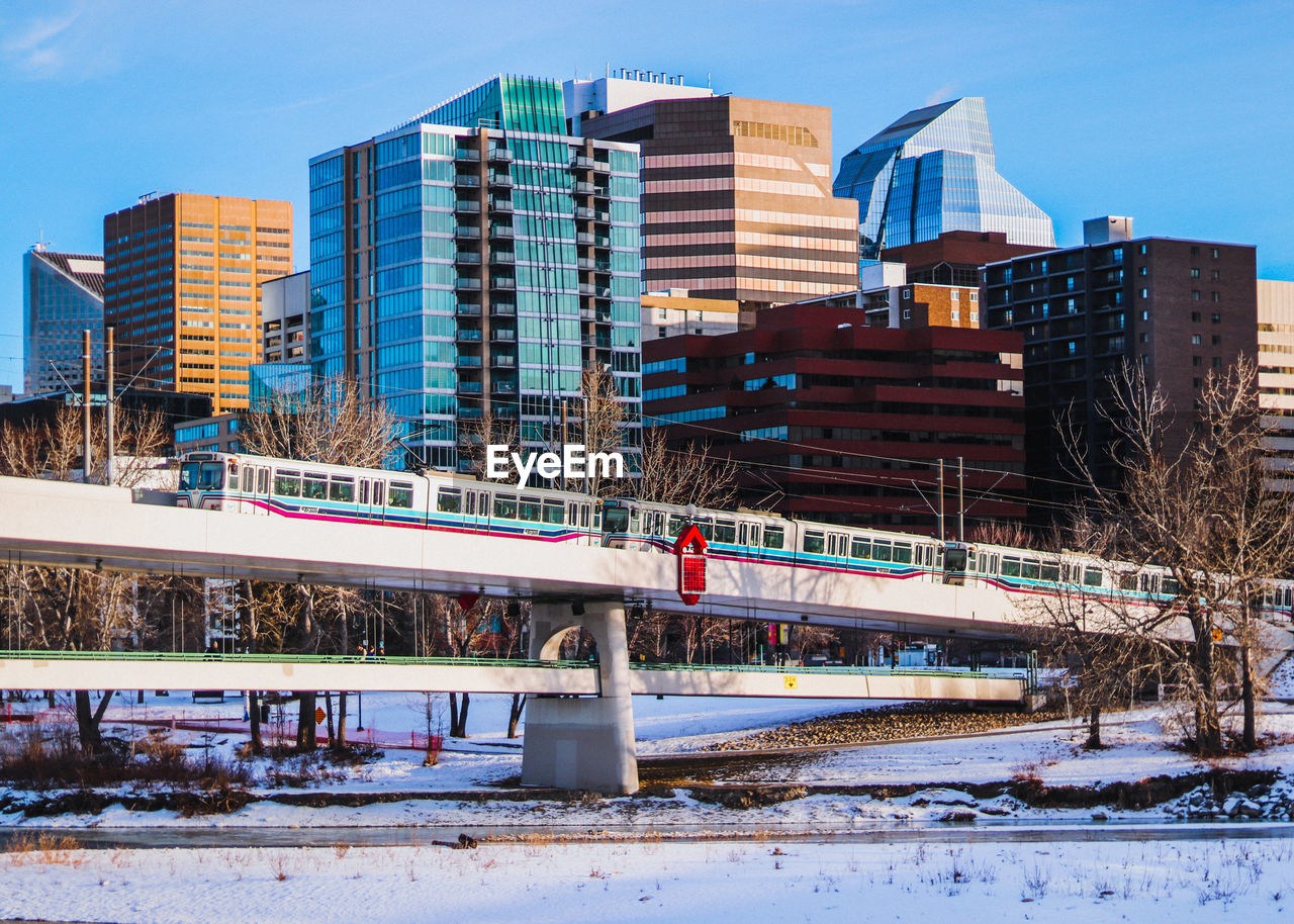 BRIDGE IN CITY AGAINST CLEAR SKY DURING WINTER