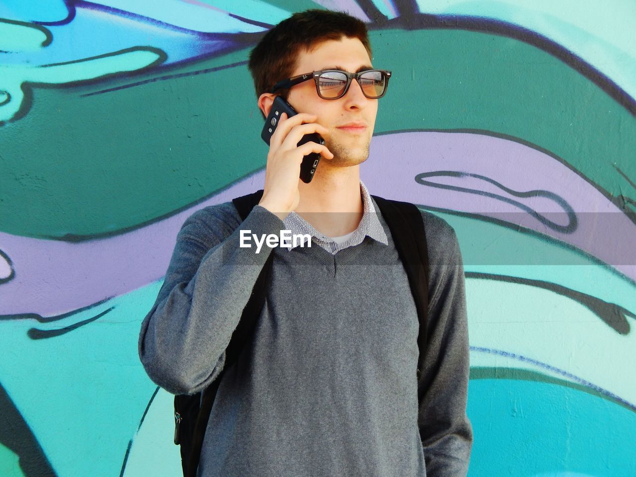 YOUNG MAN WEARING SUNGLASSES