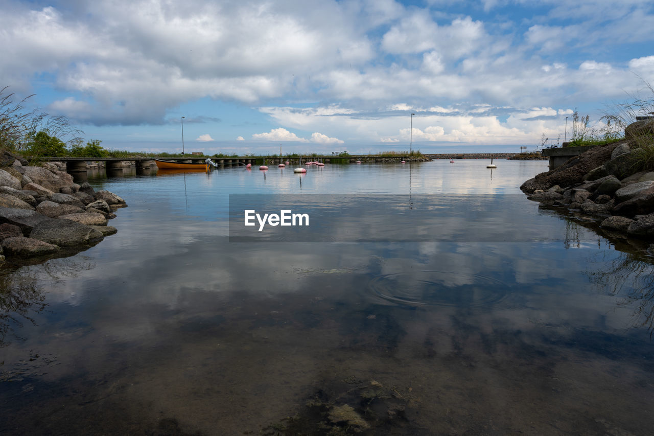 water, reflection, sky, shore, body of water, river, cloud, nature, environment, coast, architecture, land, landscape, travel destinations, scenics - nature, beach, reservoir, beauty in nature, travel, tranquility, no people, morning, built structure, bay, outdoors, tourism, city, tree, nautical vessel, building, rock, building exterior, tranquil scene, trip, holiday, vacation, day, plant, blue, mountain, dusk, transportation, coastline, ocean