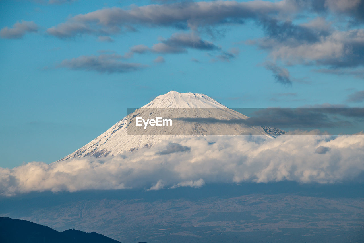 Aerial view of snowcapped mount fuji  against cloudy sky