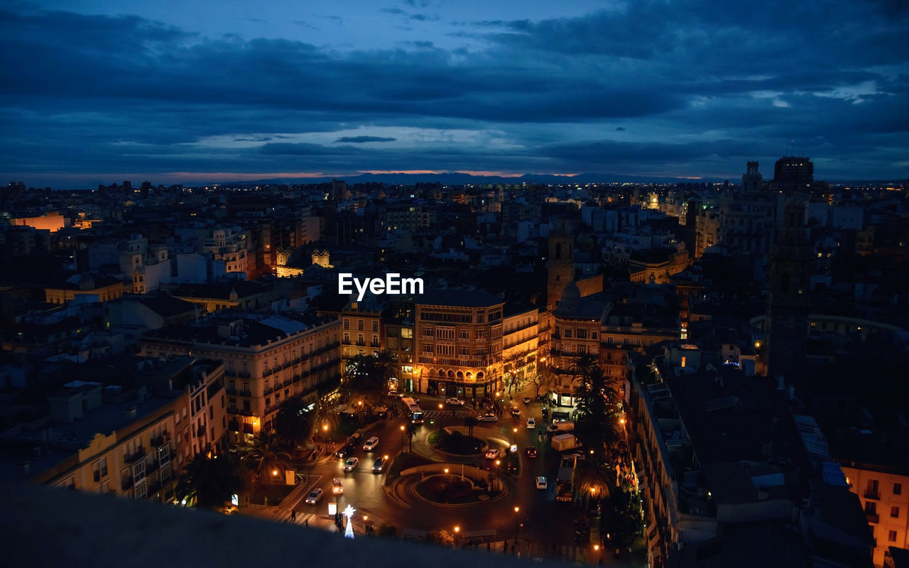 High angle view of illuminated buildings in city at night