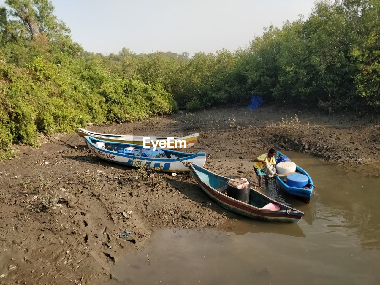 BOATS MOORED IN RIVER