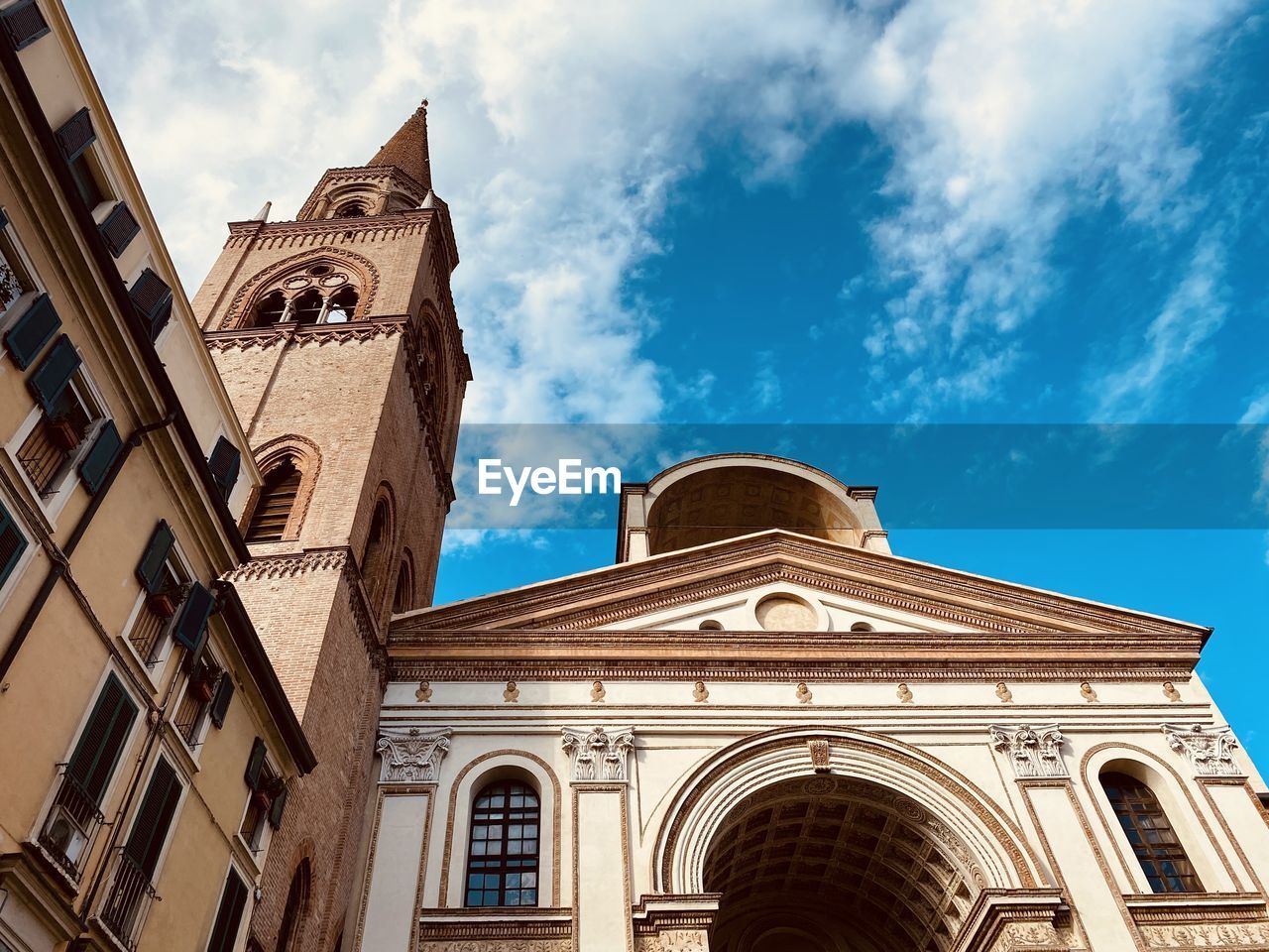 LOW ANGLE VIEW OF CATHEDRAL AGAINST SKY AND BUILDINGS