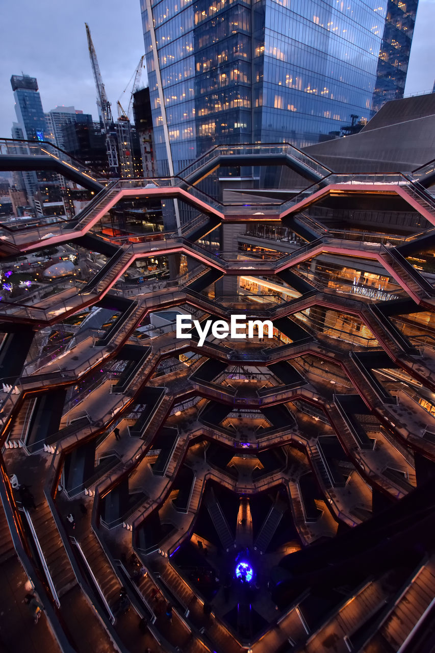 LOW ANGLE VIEW OF ILLUMINATED MODERN BUILDINGS IN CITY