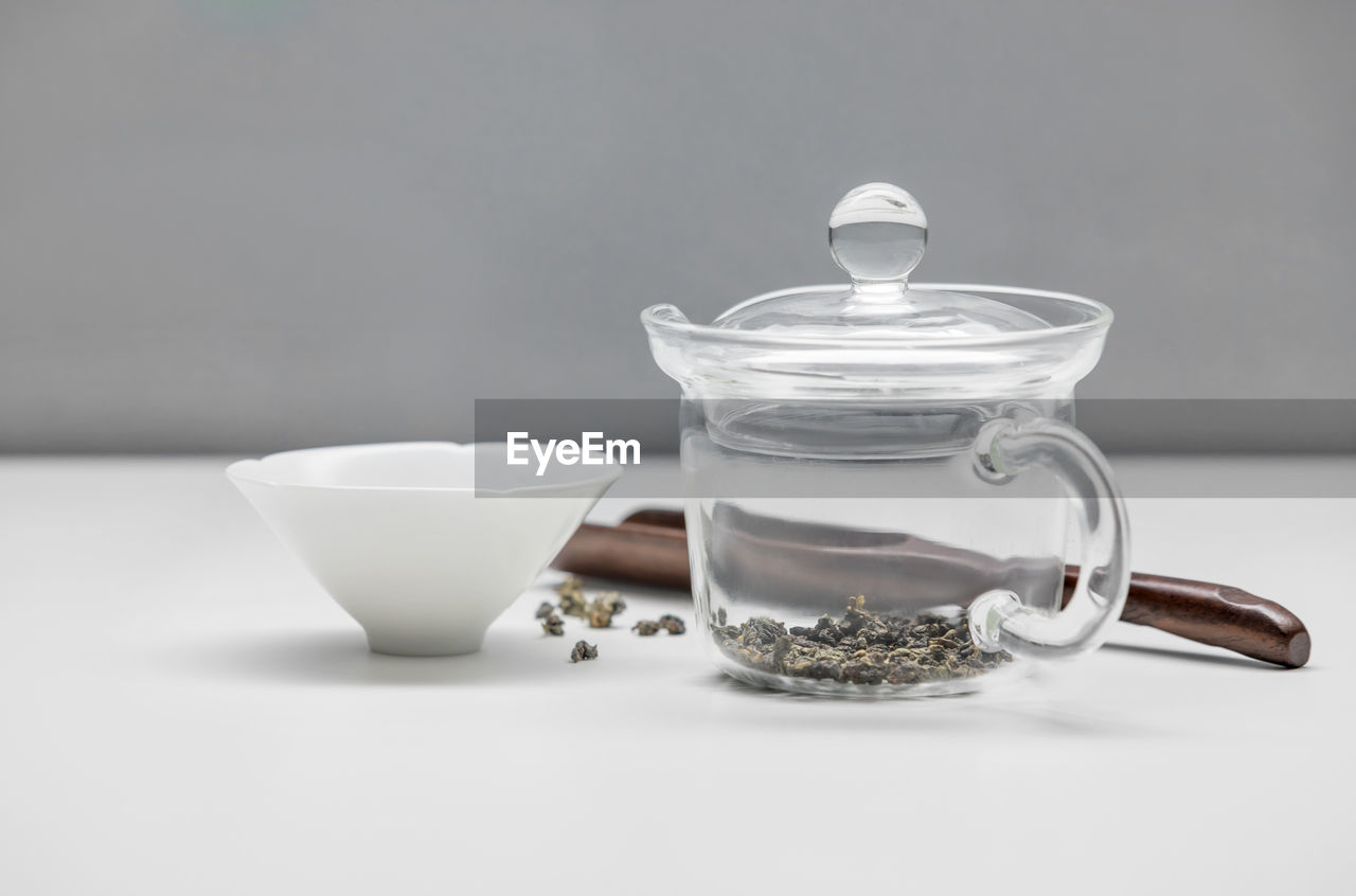 CLOSE-UP OF TEA SERVED ON TABLE AGAINST WHITE BACKGROUND