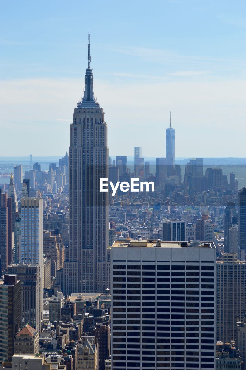 Empire state building against sky at manhattan