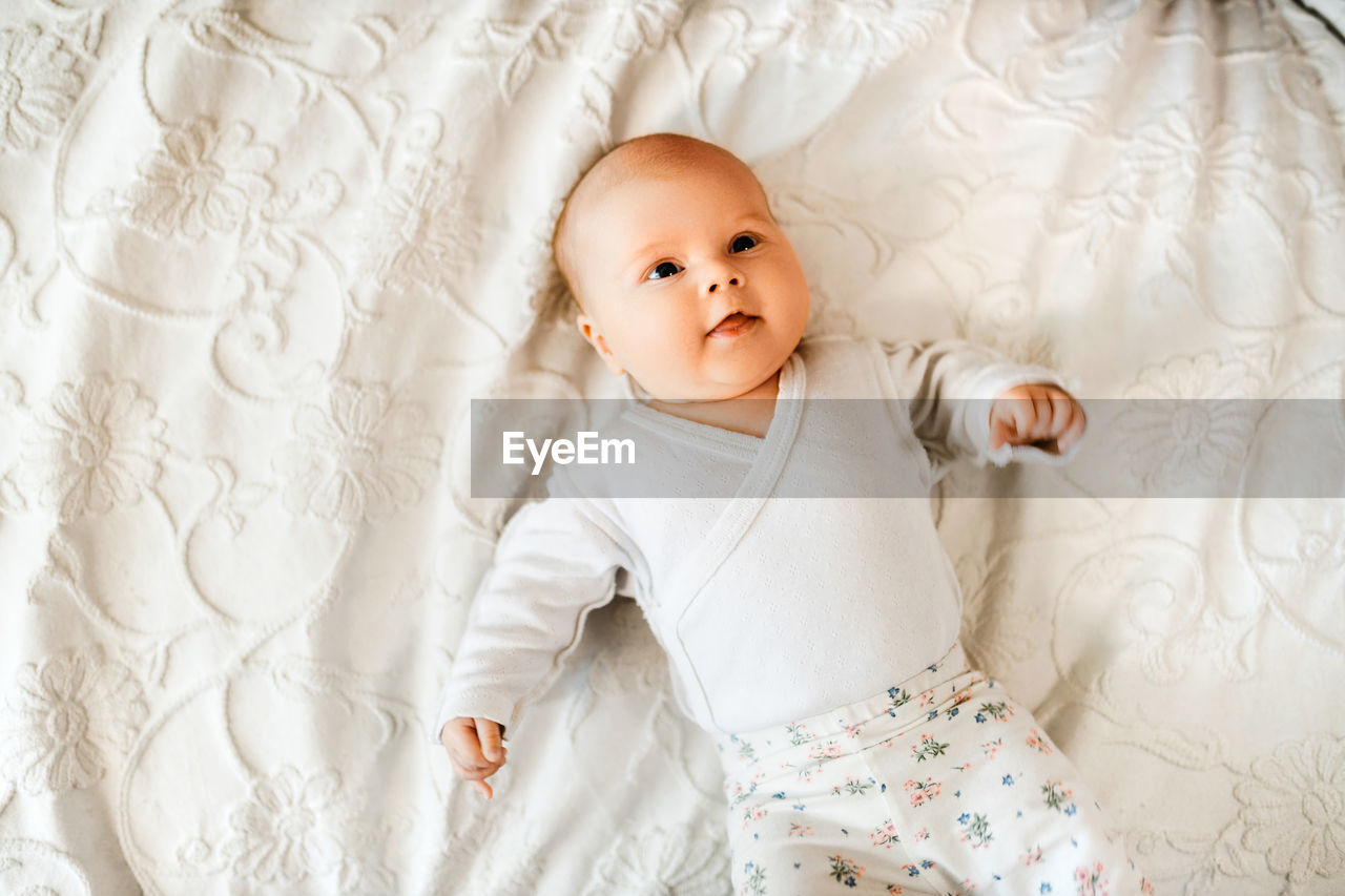 High angle view of girl sleeping on bed