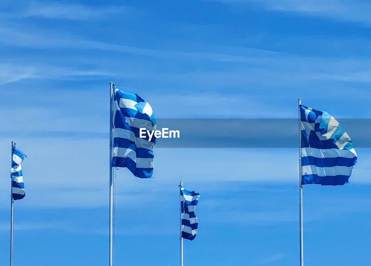 low angle view of flag against blue sky