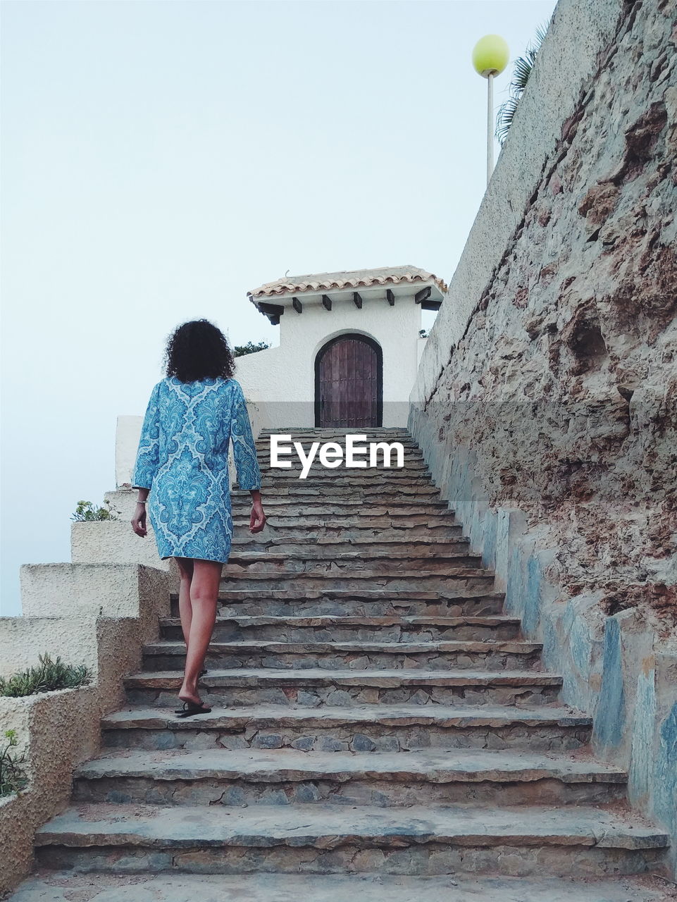 Low angle view of woman moving up on steps