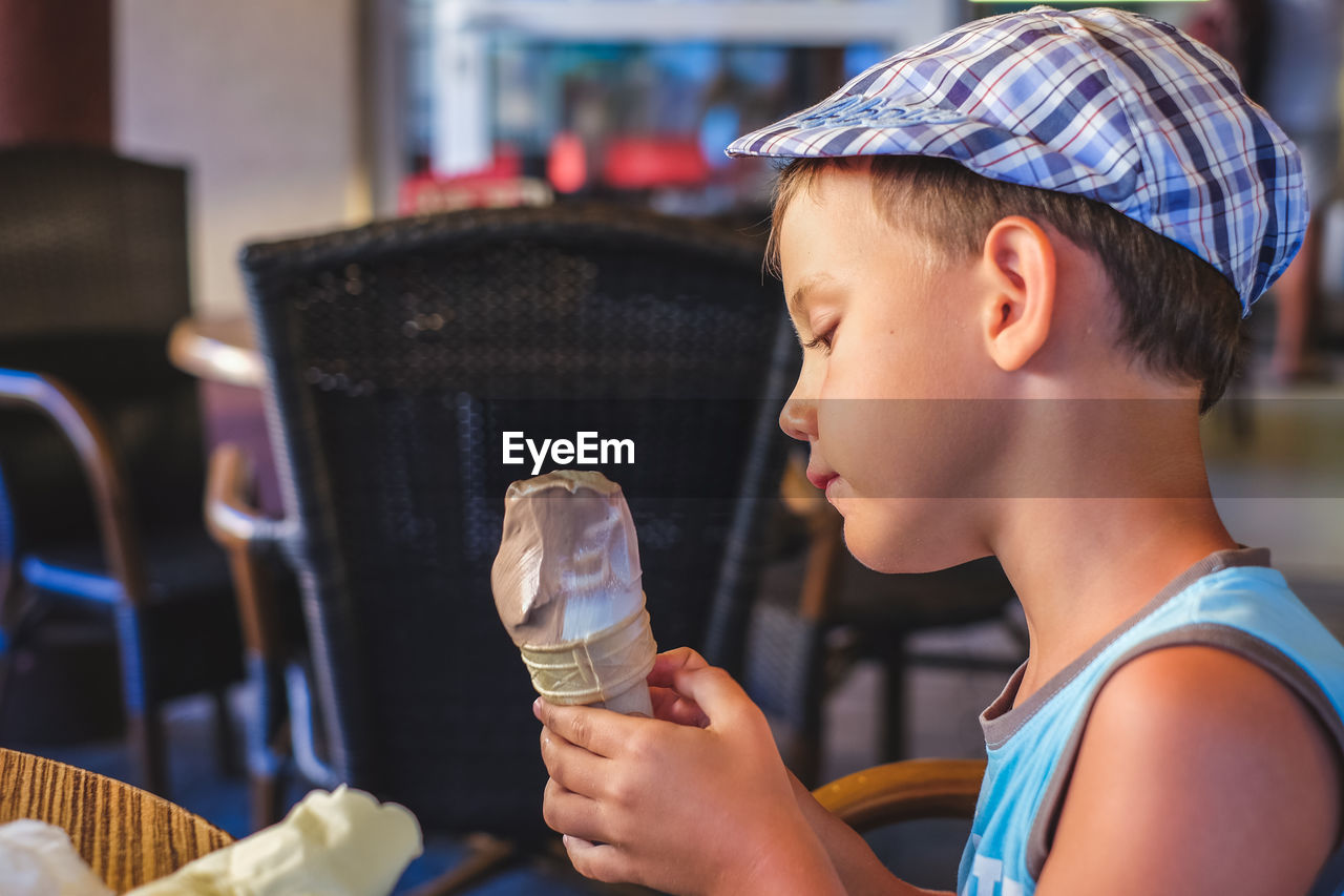 Side view of boy holding ice cream