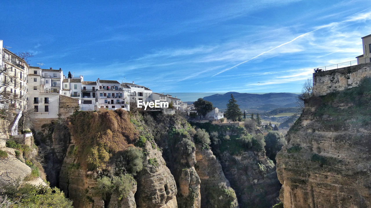 PANORAMIC VIEW OF BUILDINGS ON MOUNTAIN AGAINST SKY