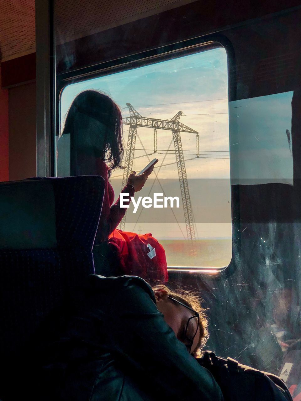 WOMAN SITTING AT TRAIN WINDOW