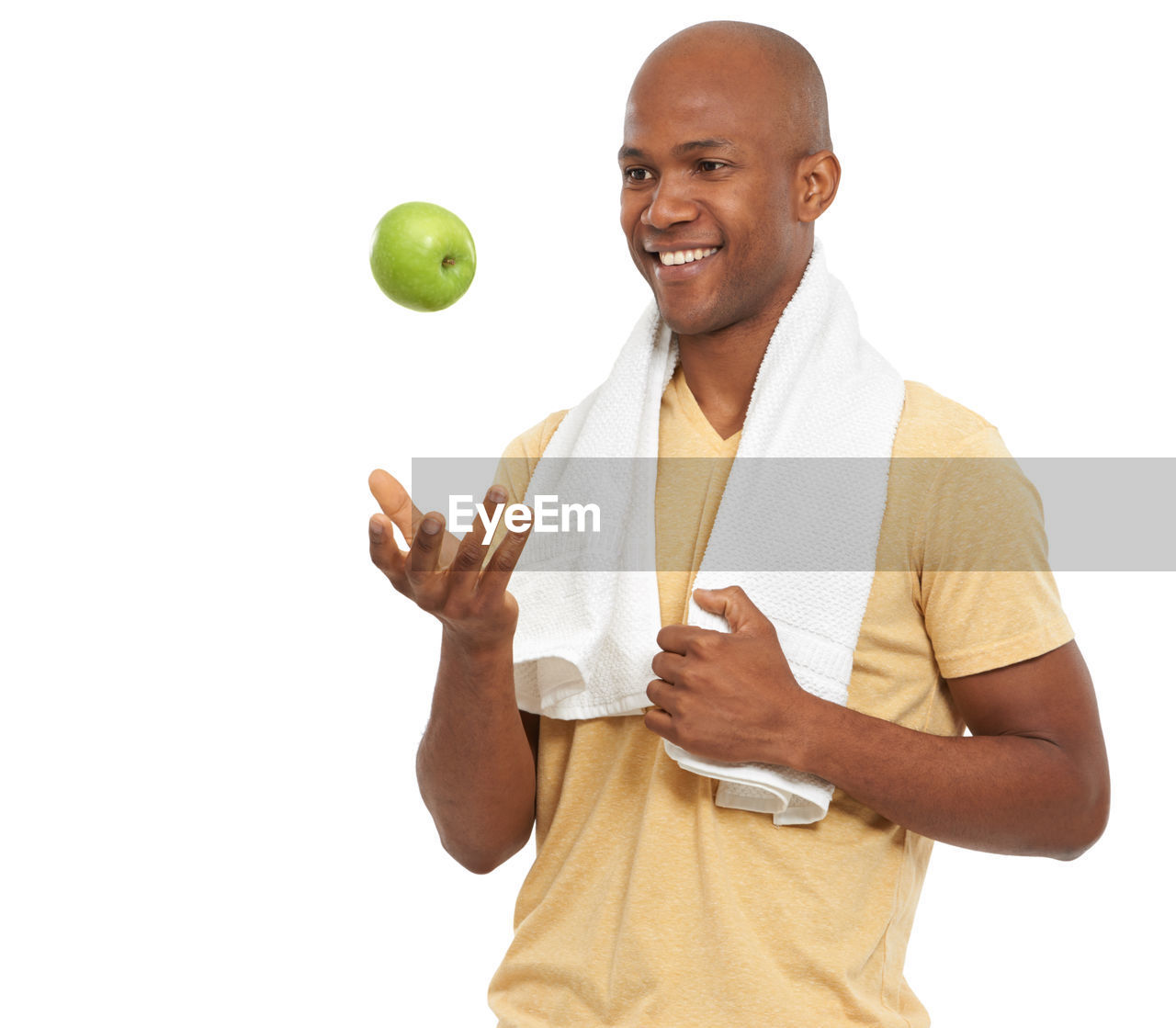 one person, adult, men, smiling, white background, studio shot, cut out, shaved head, finger, sports, happiness, ball, wellbeing, portrait, hand, lifestyles, person, waist up, holding, casual clothing, indoors, arm, healthy eating, standing, young adult, cheerful, clothing, vitality, emotion, copy space, relaxation, looking at camera, smile, teeth, exercising, front view, fruit, tennis