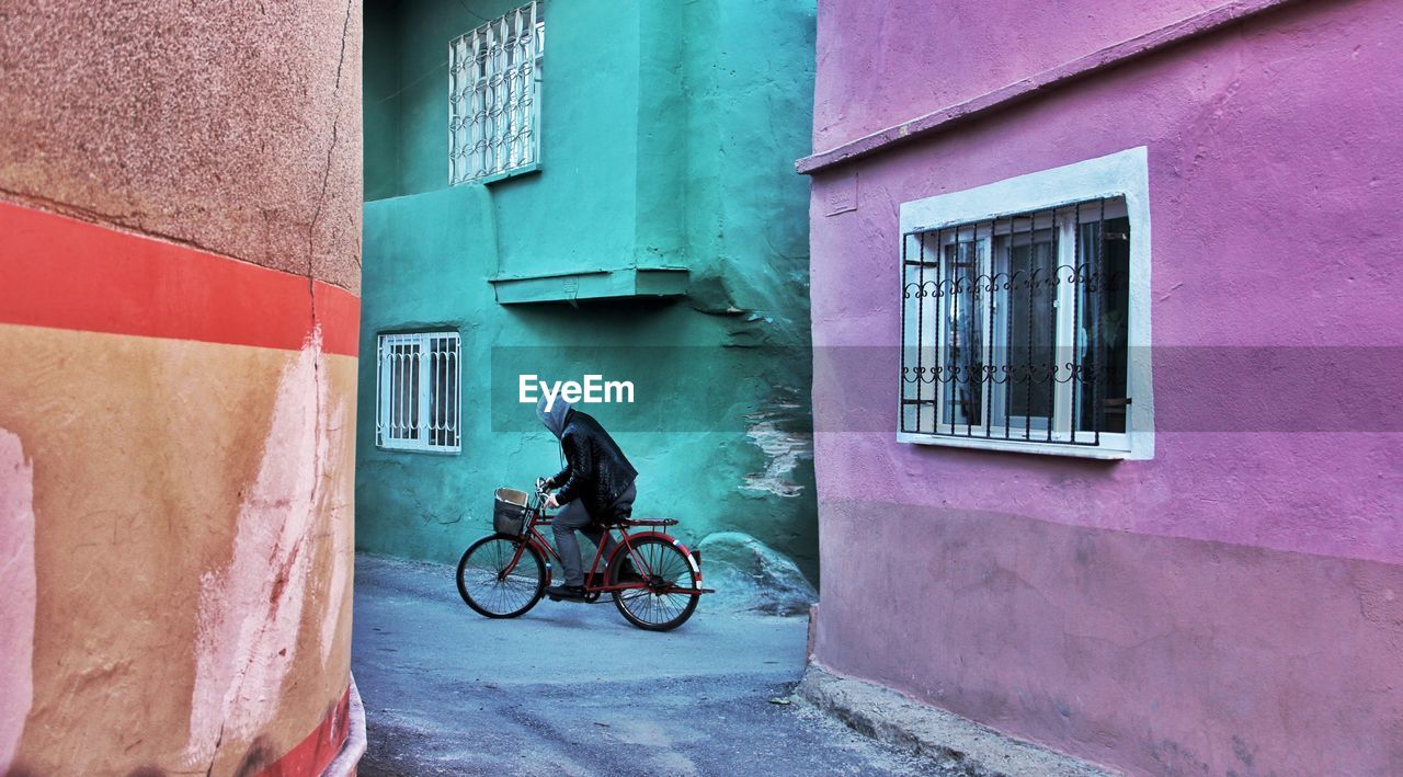 Bicycle on the street between colored walls